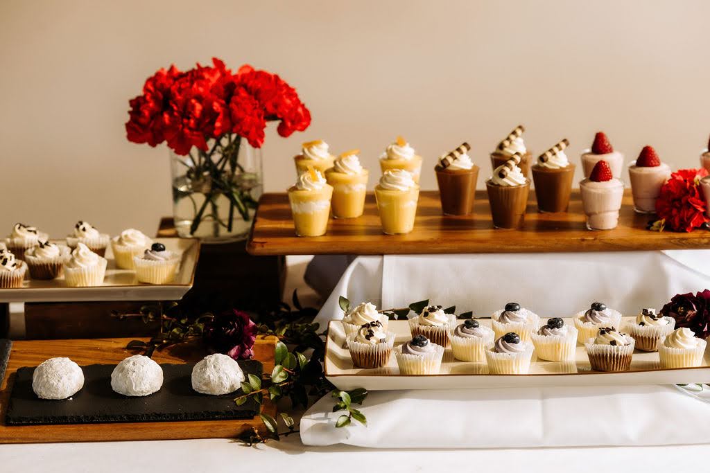 wedding dessert table catering display with cupcakes, mini desserts and dessert shooters
